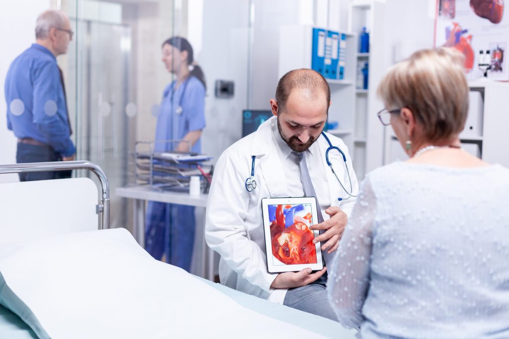 Proquimed Laboratorio Clínico - El tabaquismo | Physician pointing at heart disease using tablet pc and talking with patient about diagnosis. Medical services medicine healthcare well-being support, physician working &  _